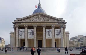A photo of the exterior of the Pantheon in Paris. A French flag flies at the top of the dome.