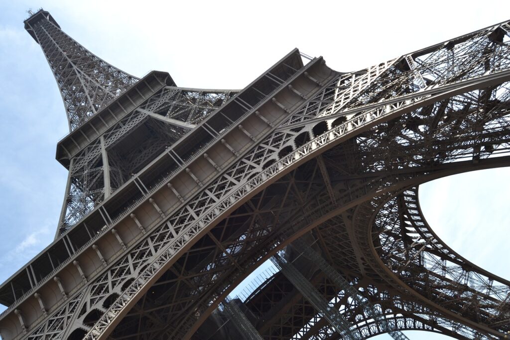 A photo of the Eiffel Tower looking up from underneath it.