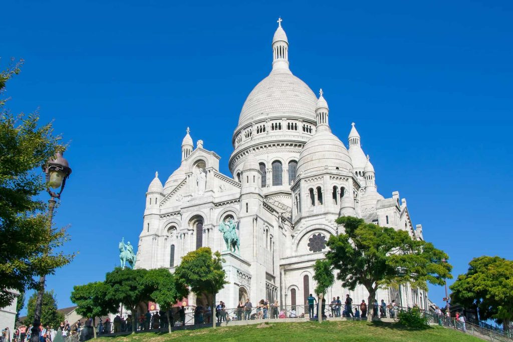 A photo of the Sacre Coeur on the top of Montmartre, one of the churches to visit in Paris