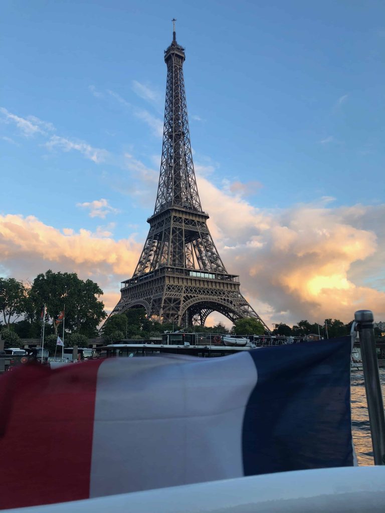 A picture of the Eiffel Tower with the French flag below. One of my favourite sights as an immigrant to France.