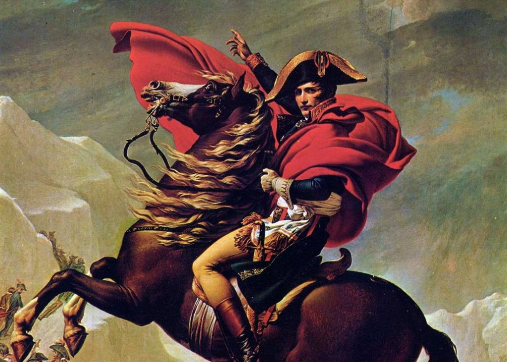 A photo of the famous painting, Napoleon Crossing the Alps, by Jacques-Louis David. Napoleon is on a horse that is reared up, looking directly at the viewer, with his hand raised up.