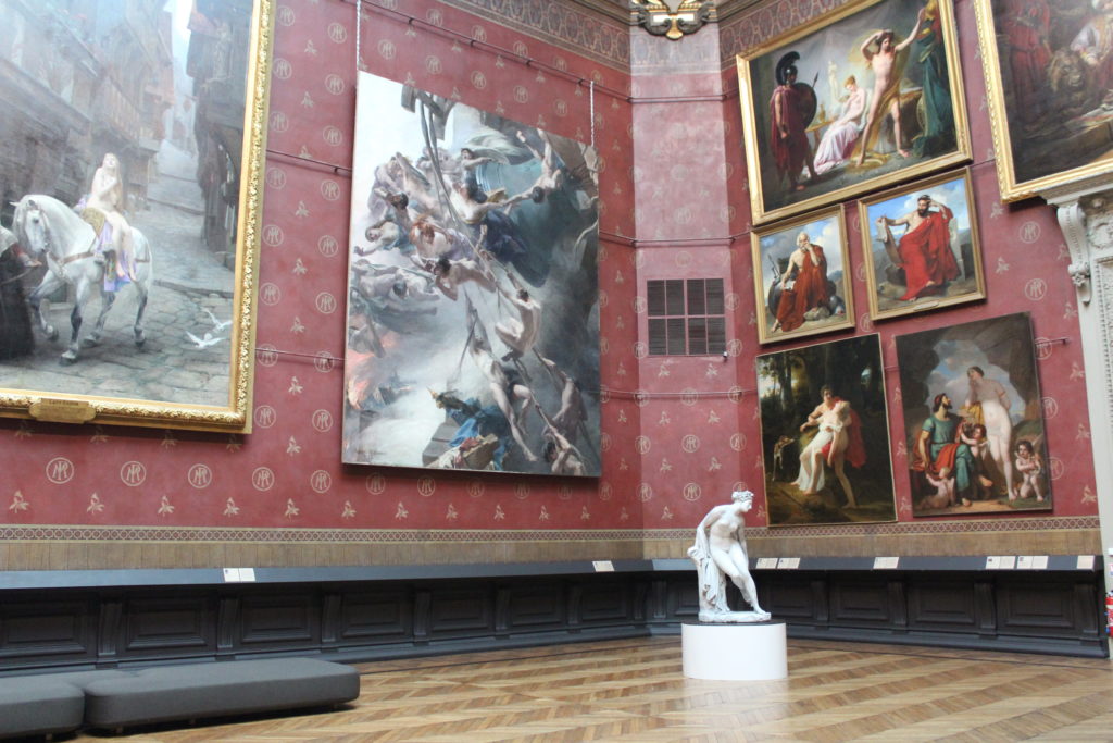 A photo of the Grand Salon at the Musee de Picardie, and the painting Les Voix du Tocsin hanging in the corner of the room.