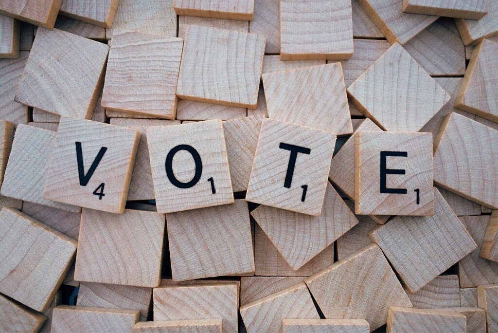 A photo of the word vote spelled out in wooden blocks.