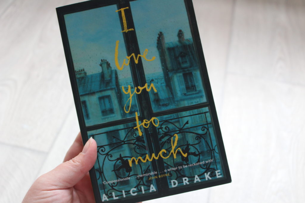 A close up photo of a hand holding the book I Love You Too Much