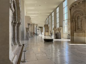 A photo looking down a gallery of thee Cité de l'Architecture et du Patrimoine. Several statues and plaster casts can be seen.