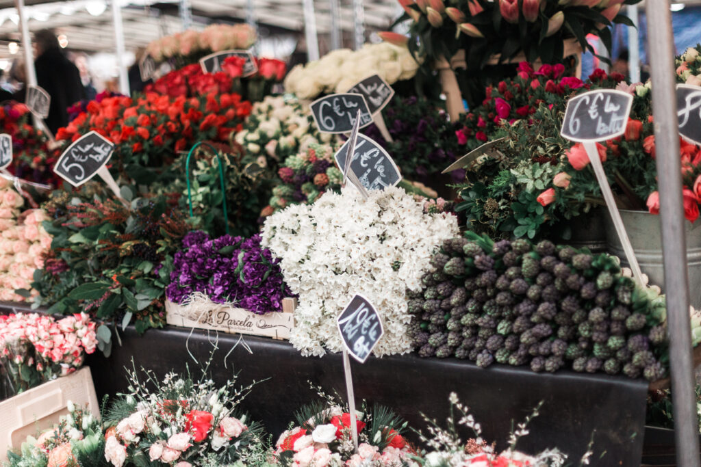 A photo of flowers on display at a market.