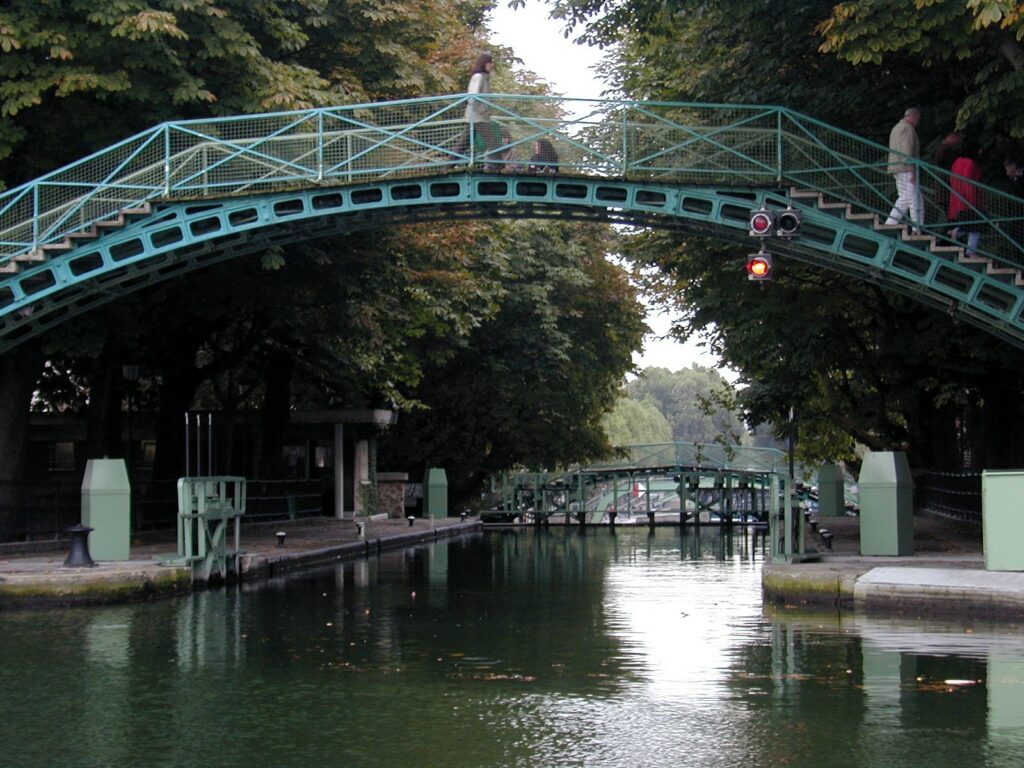 A photo of a wrought iron bridge over the Canal Saint Martin.