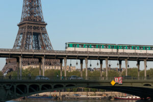 A photo of a Metro train crossing the Pont de Bir Hakeim in the 15e arrondissement of Paris. The Eiffel Tower is in the background.