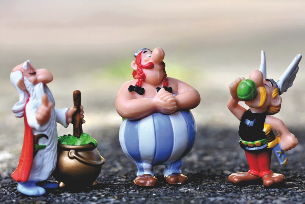 A photo of the characters from the Astérix comic strip, who form the theming of Parc Astérix. The three characters are plastic characters in a line depicting Asterix, Obelix, and Panoramix.